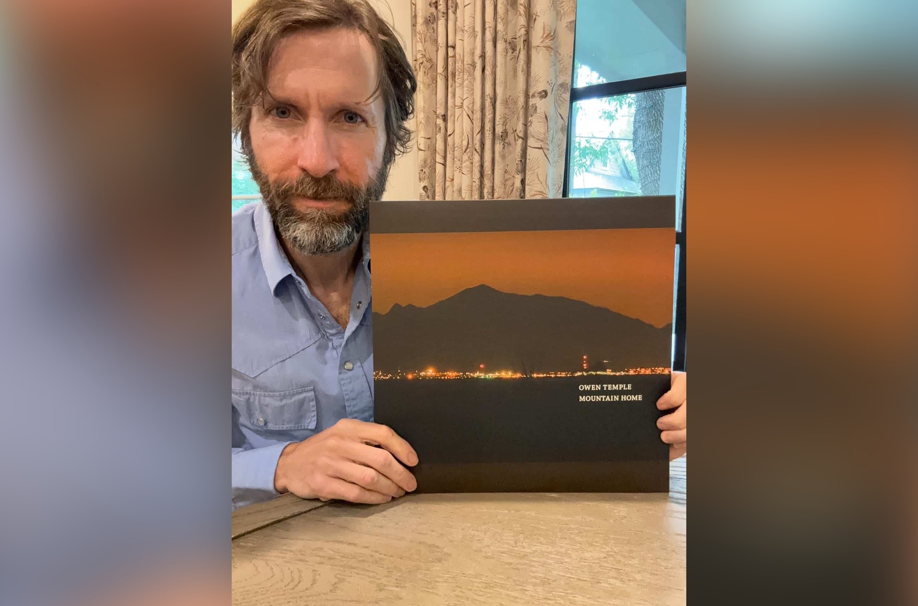 Owen Temple holding the Mountain Home vinyl LP
