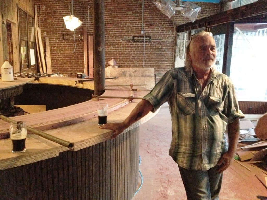 Hal Ketchum beside a bar under construction