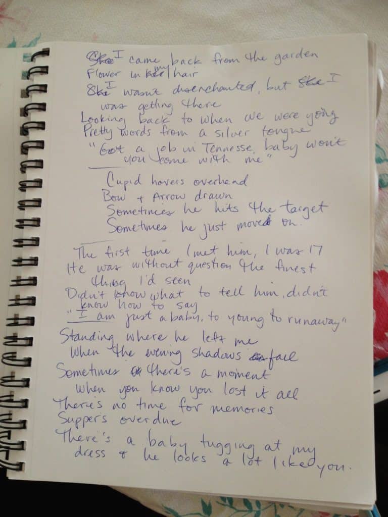 Handwritten draft of the lyrics to He Looks a Lot Like You in a spiral notebook