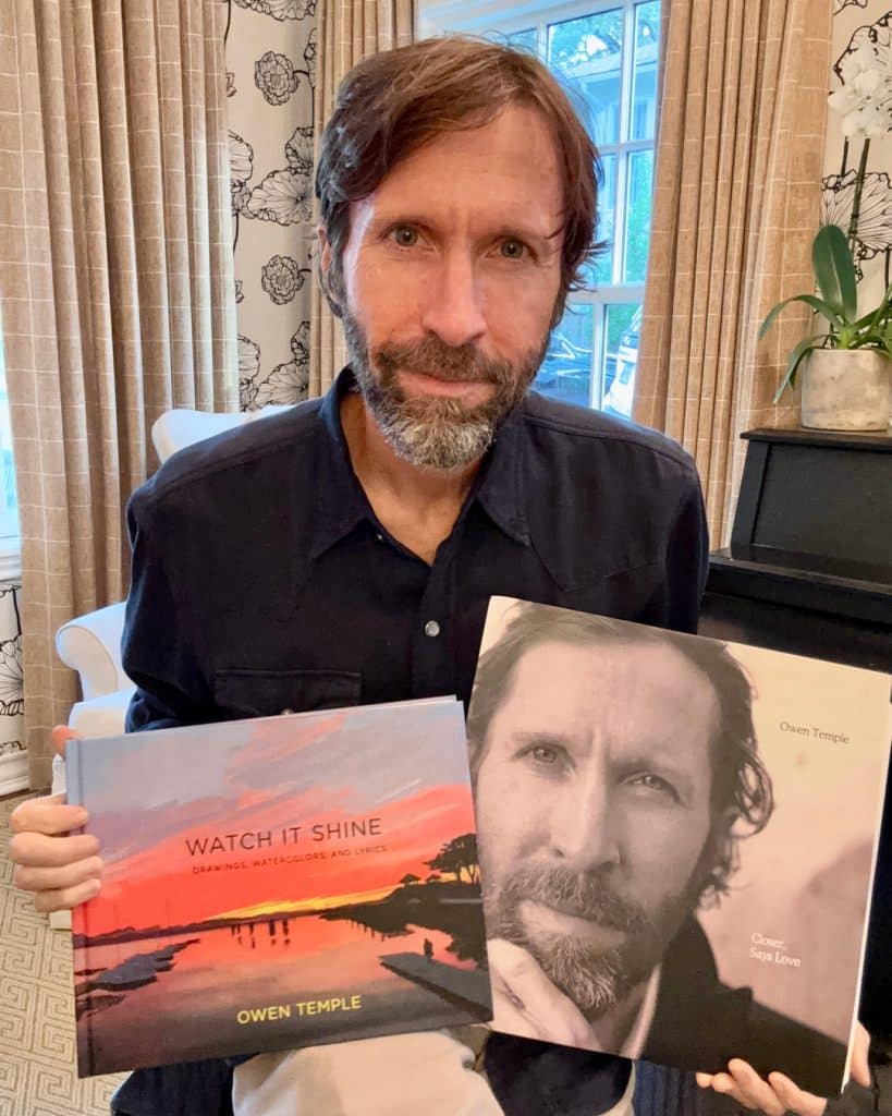 Owen Temple holding the Closer, Says Love vinyl LP and the Watch It Shine art book